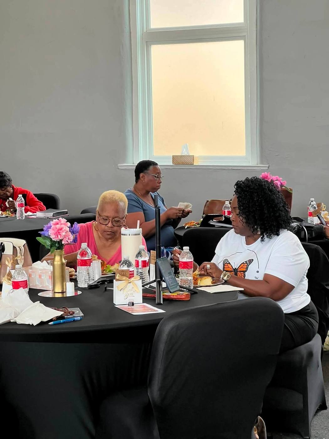 Attendees sharing a meal together at a round table during Breaking Bread.