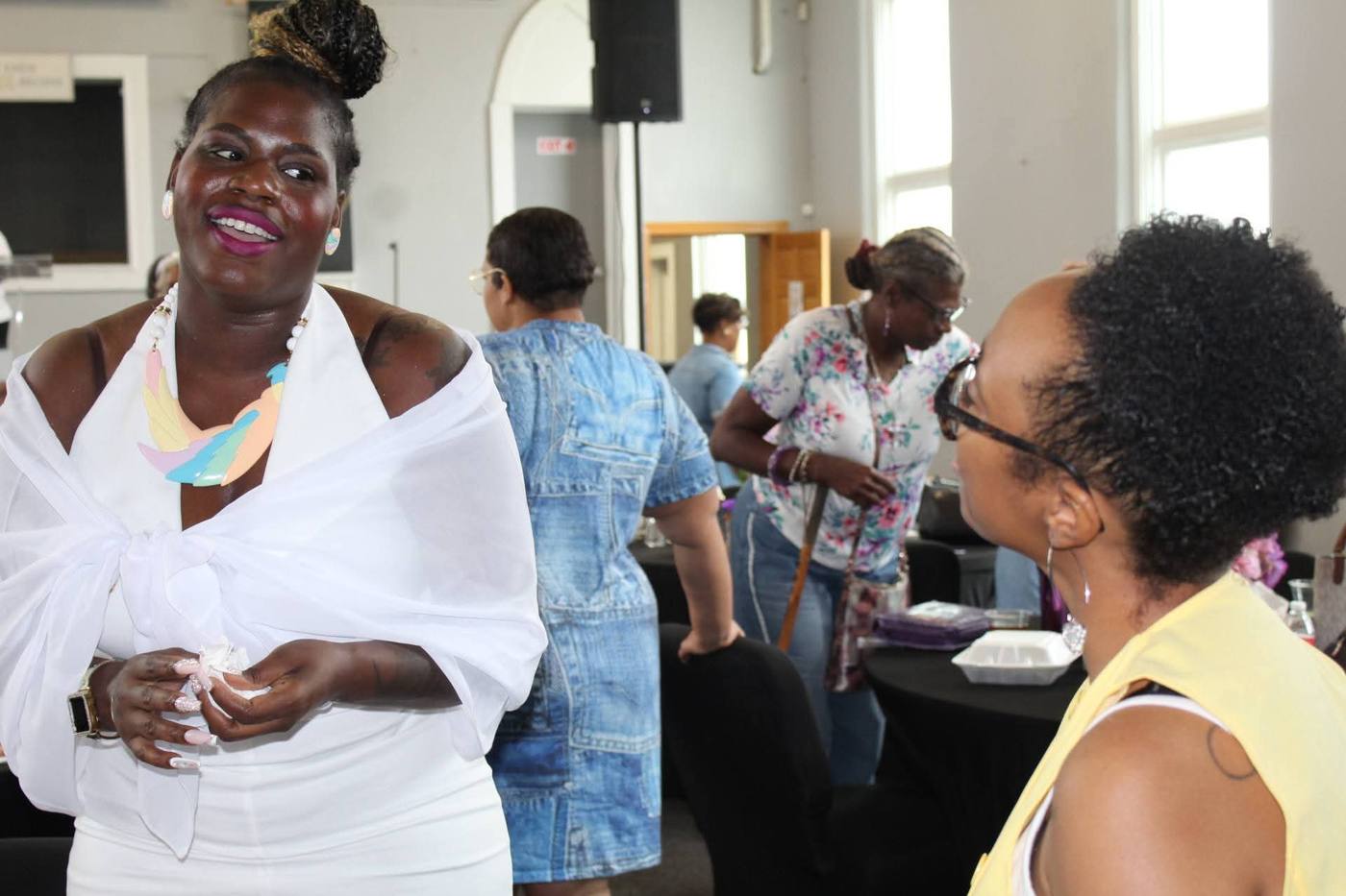 Two women in warm conversation during fellowship time.