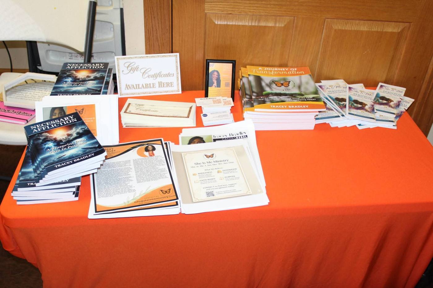 She Is Me Ministry resource table with Tracey Bradley's books Necessary Affliction and A Journey of Transformation.