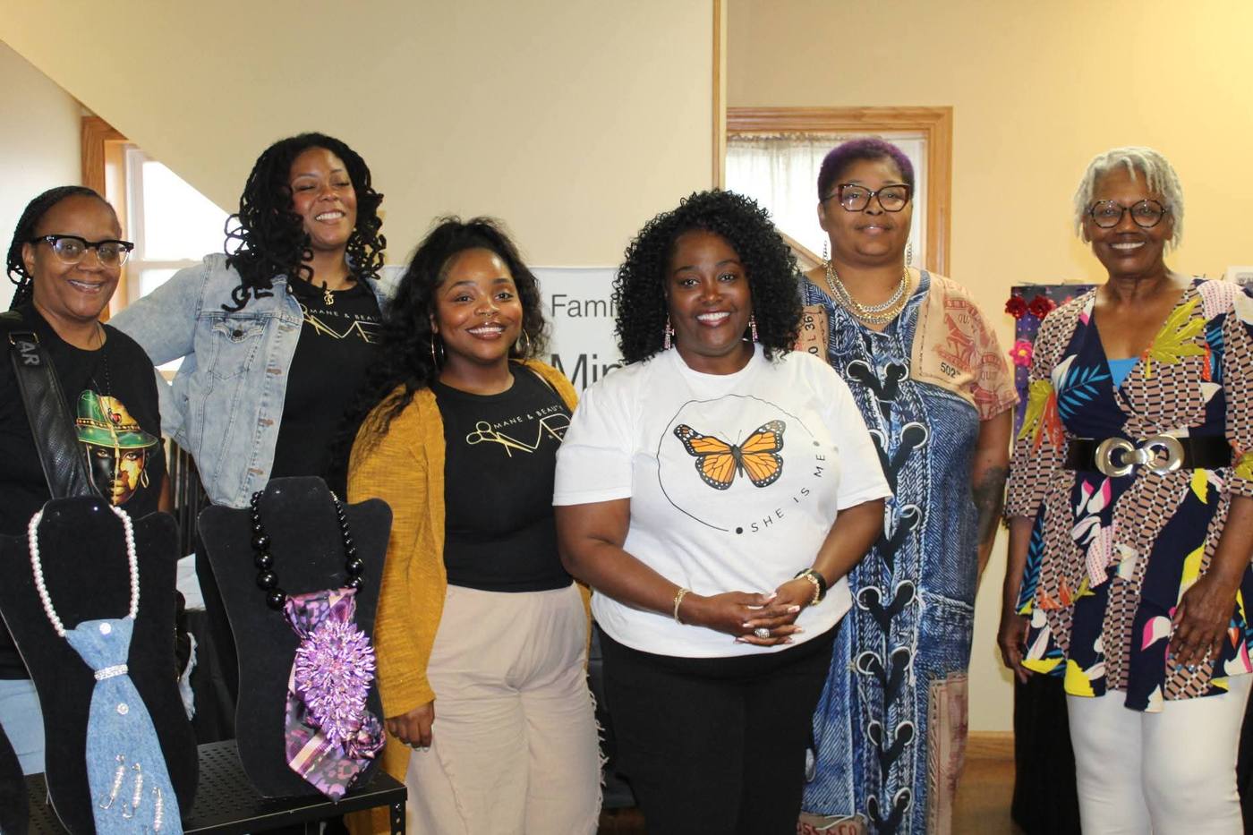 Group of six vendors and organizers gathered together, smiling for a portrait.