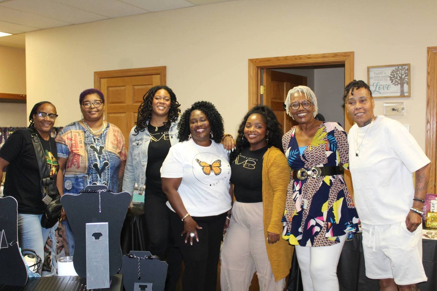 Wide group portrait of seven vendors and organizers together at the event.